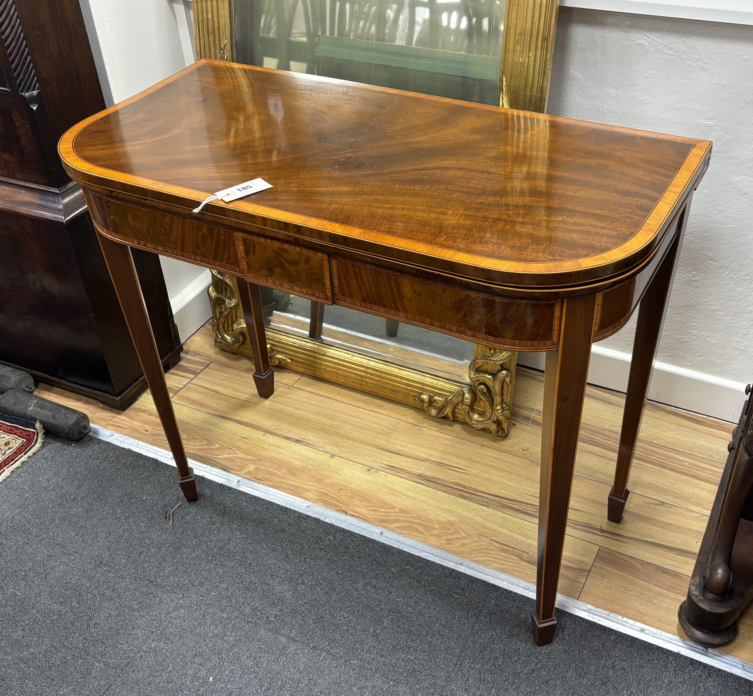 A George III satinwood banded mahogany folding card table, width 91cm, depth 45cm, height 75cm